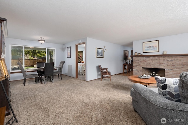 living room with a brick fireplace, a textured ceiling, and carpet floors