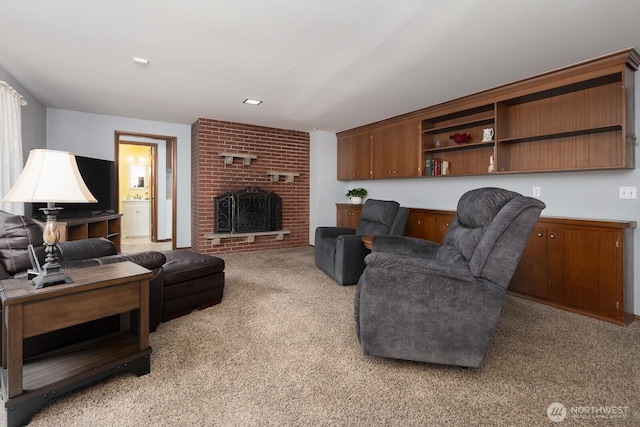 living area featuring light carpet and a fireplace