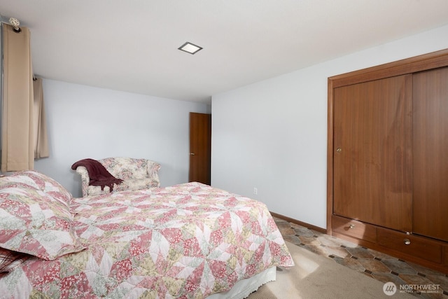 carpeted bedroom featuring baseboards