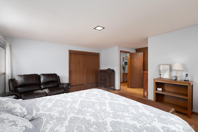 bedroom featuring a closet and wood finished floors