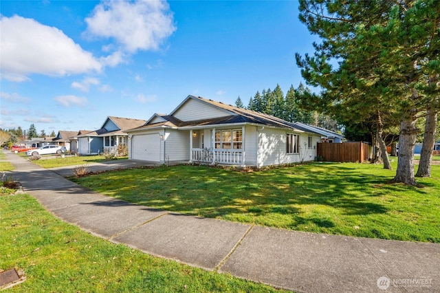 ranch-style home with fence, a porch, a front yard, a garage, and driveway