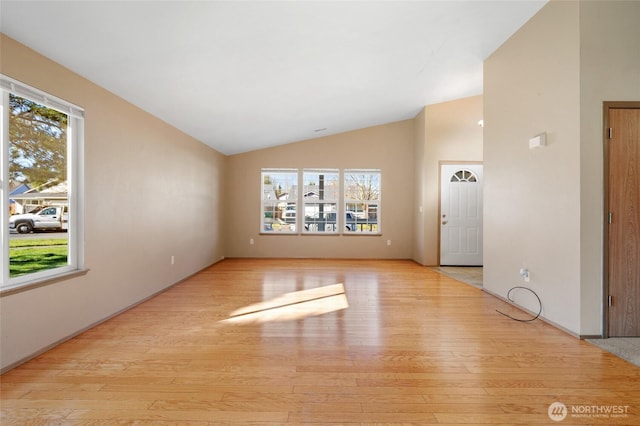 unfurnished living room featuring vaulted ceiling and wood finished floors