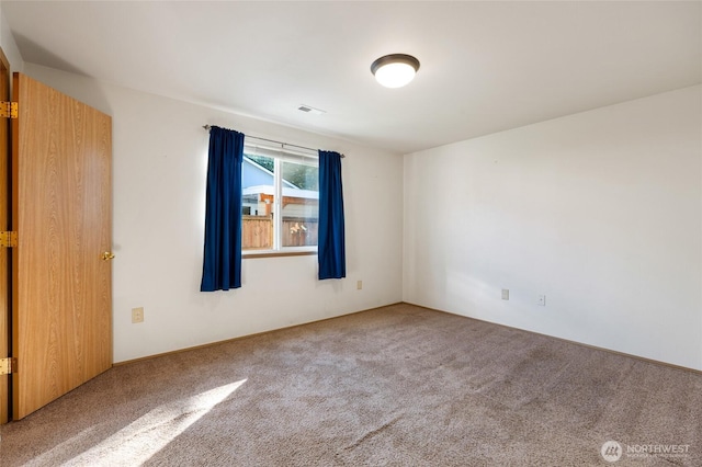 empty room featuring carpet flooring and visible vents