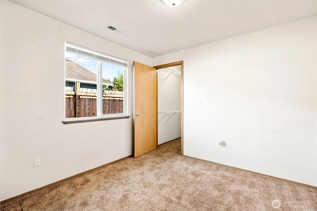 carpeted empty room with visible vents