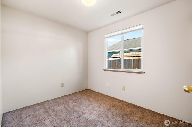 unfurnished room with visible vents and carpet flooring