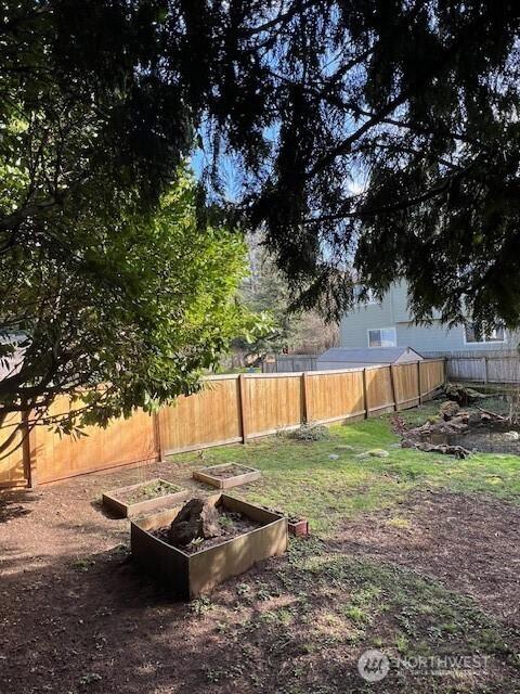 view of yard featuring fence private yard and a garden