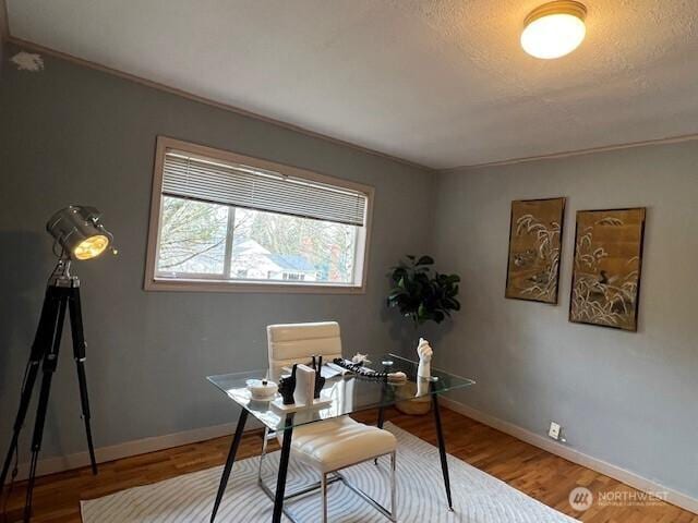 office area featuring a textured ceiling, wood finished floors, and baseboards