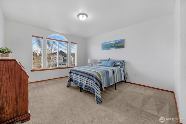 carpeted bedroom with baseboards