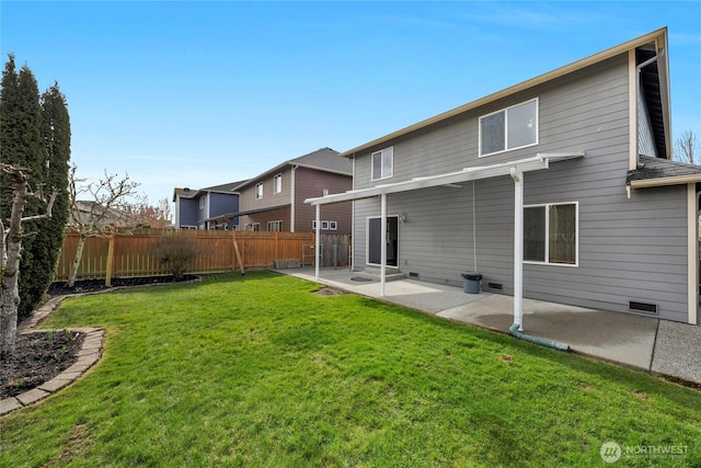 back of house with a patio area, crawl space, a lawn, and fence