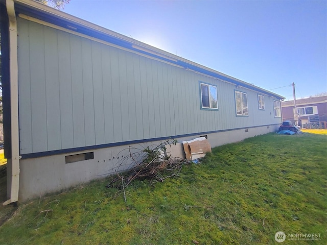 view of property exterior with crawl space and a yard