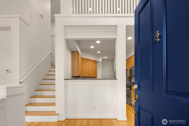 foyer entrance featuring stairway, recessed lighting, and light wood-style flooring