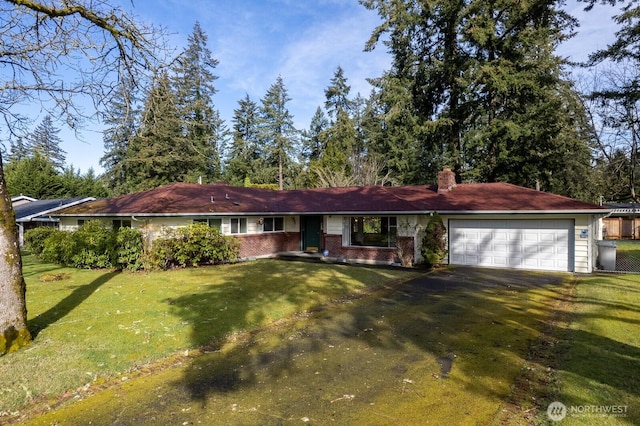 ranch-style house with driveway, a front lawn, a chimney, and an attached garage