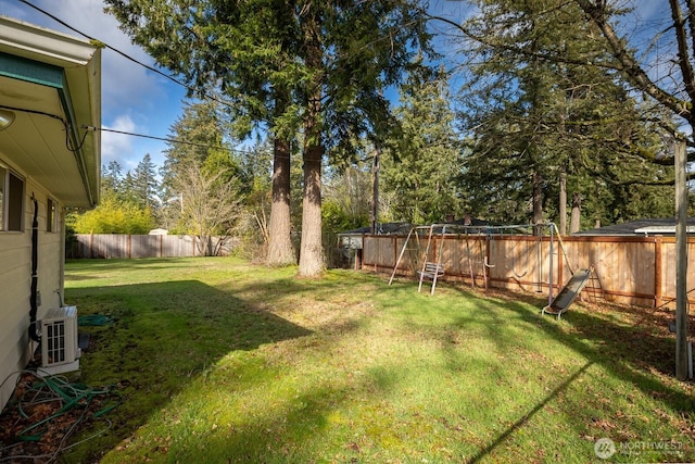 view of yard with ac unit and a fenced backyard