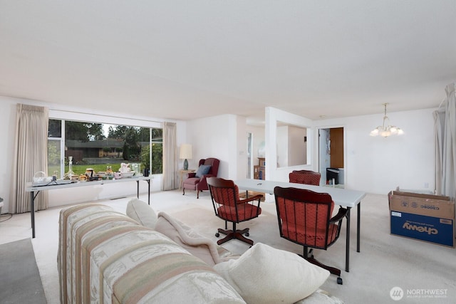 living area featuring a notable chandelier and carpet flooring