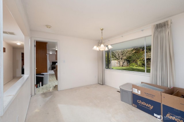 dining area with visible vents, an inviting chandelier, and carpet floors