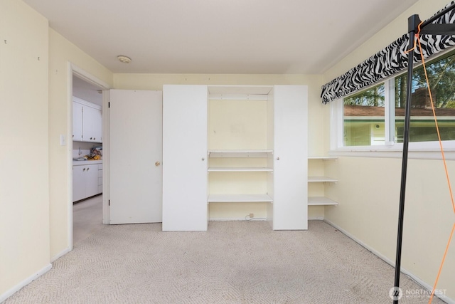 unfurnished bedroom featuring carpet flooring and baseboards