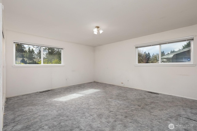 carpeted spare room with visible vents