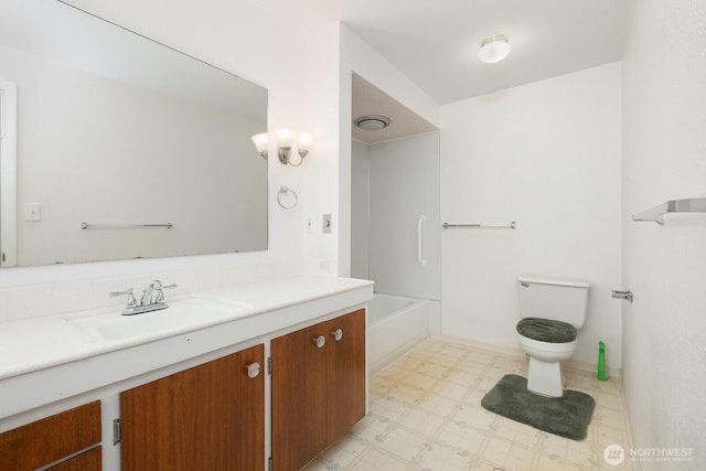 bathroom with tile patterned floors, vanity, toilet, and a bathtub