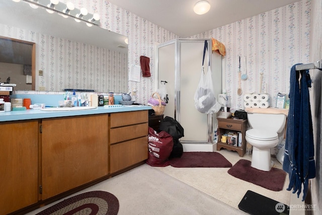 full bath featuring a shower stall, wallpapered walls, vanity, and toilet