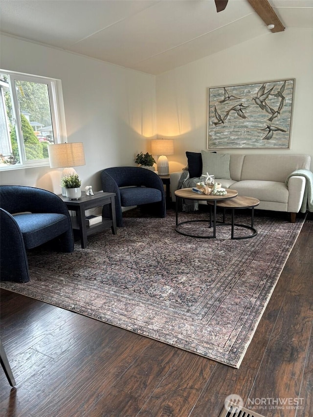 living room featuring hardwood / wood-style floors and vaulted ceiling with beams