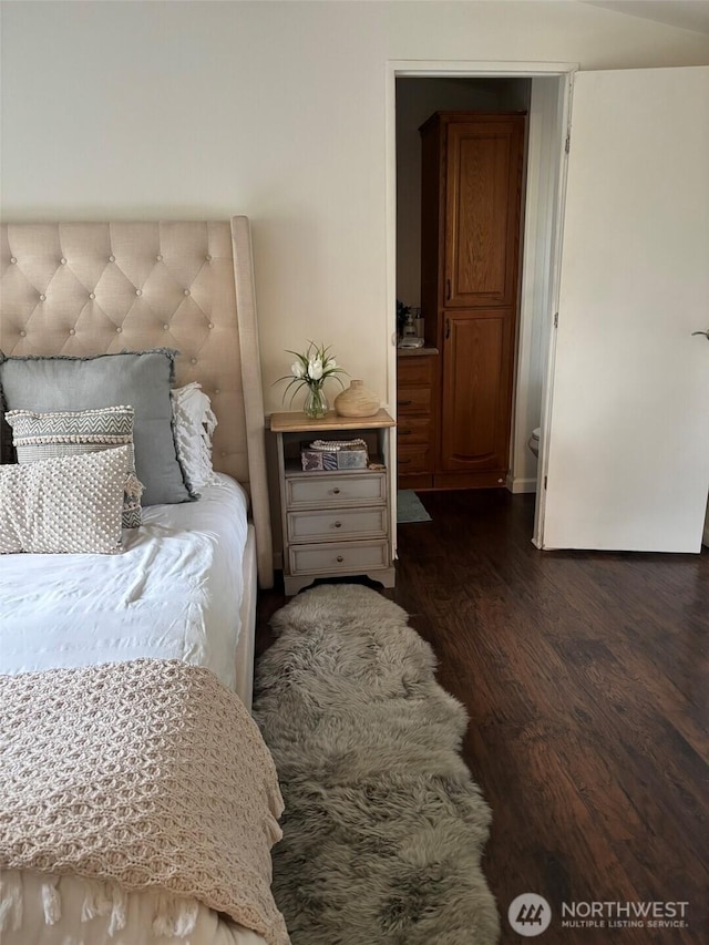 bedroom featuring dark wood-type flooring