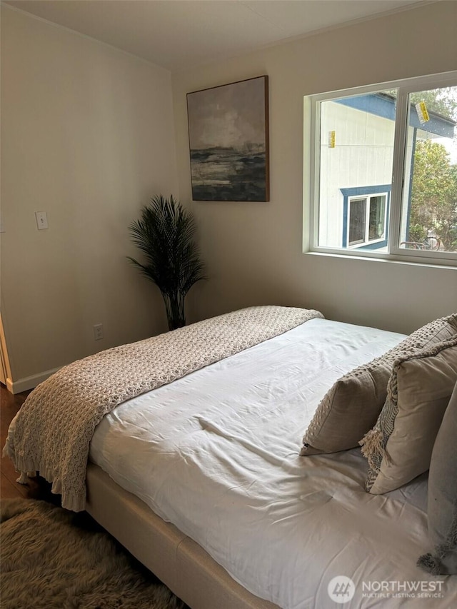 bedroom with dark wood-style floors