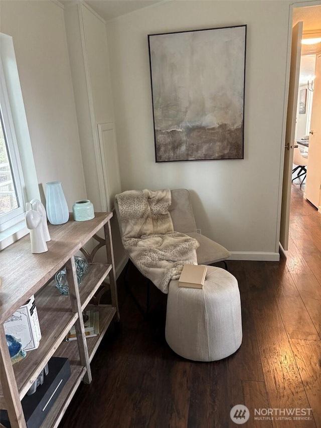 sitting room with baseboards and wood-type flooring