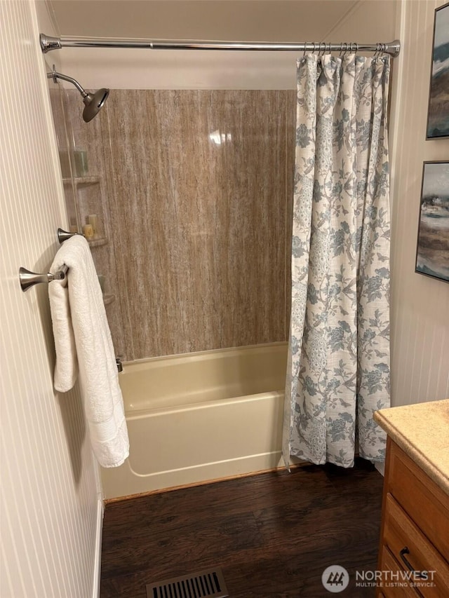 full bath with vanity, wood finished floors, shower / bath combo, and visible vents