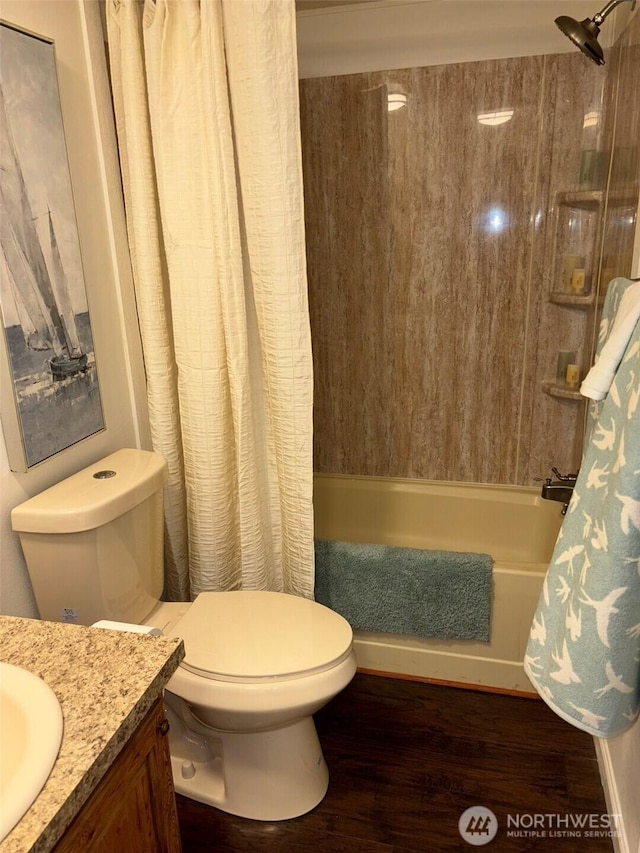 full bath featuring vanity, toilet, shower / bath combo, and wood finished floors