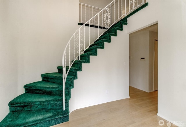 stairs featuring baseboards and wood finished floors