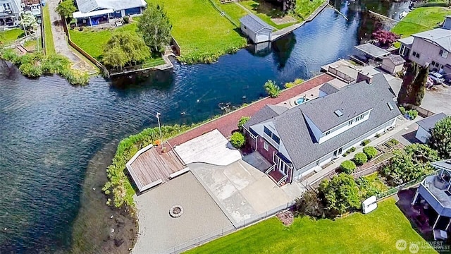 drone / aerial view with a water view and a residential view