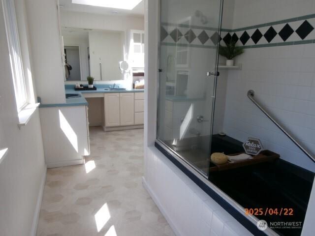 701 173rd St S, Spanaway, WA 98387 - bathroom with a shower with door, tile patterned floors, vanity, and baseboards