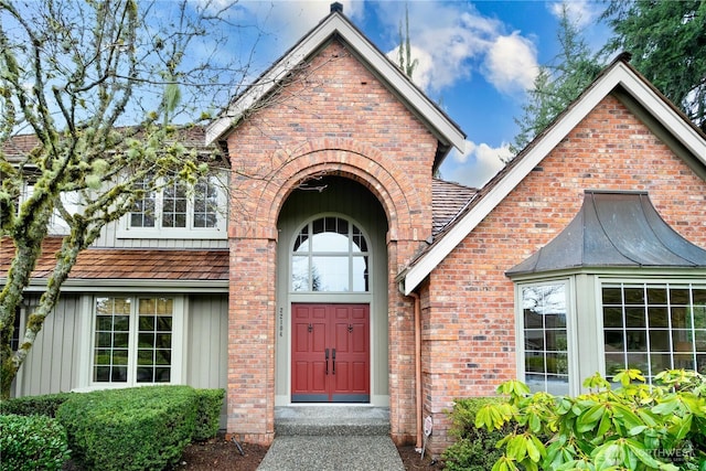 property entrance featuring brick siding and board and batten siding