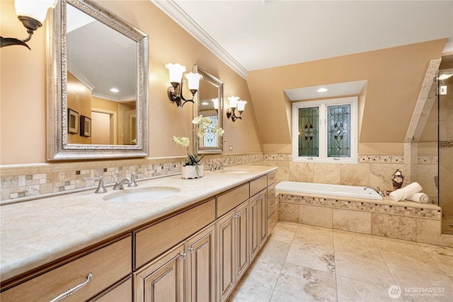 full bath featuring a sink, a bath, and crown molding