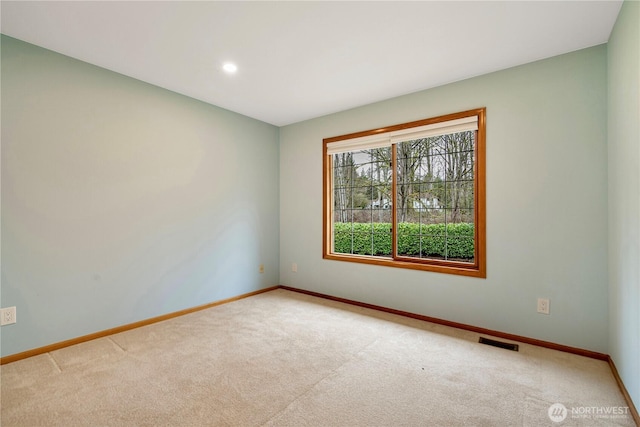 carpeted spare room with recessed lighting, baseboards, and visible vents