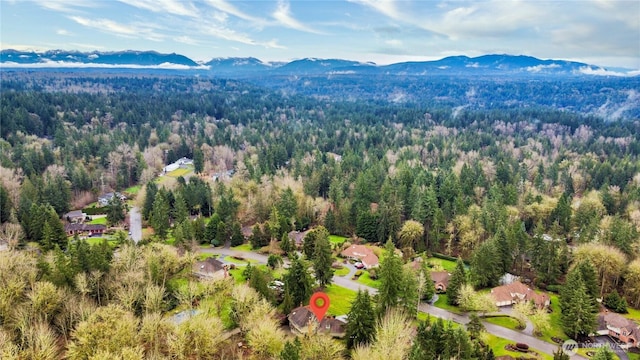 drone / aerial view with a mountain view and a wooded view