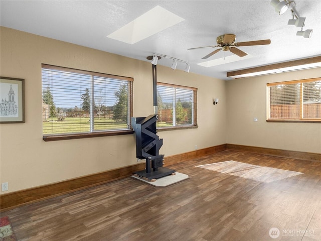 interior space with wood finished floors, a healthy amount of sunlight, and a textured ceiling