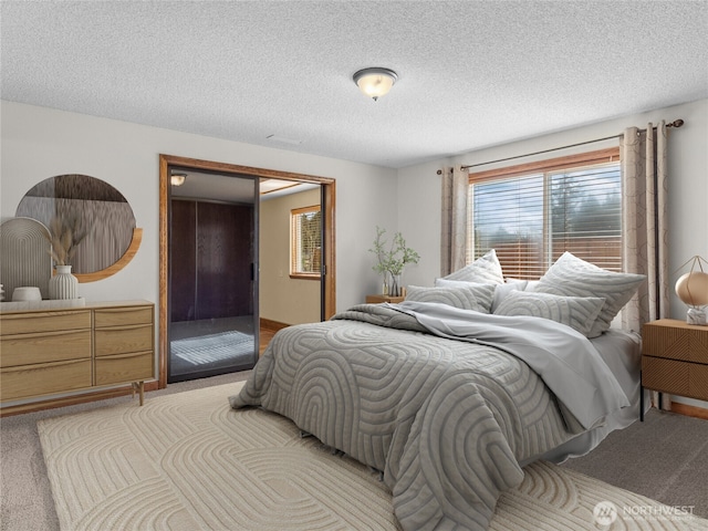 bedroom featuring a textured ceiling and carpet floors