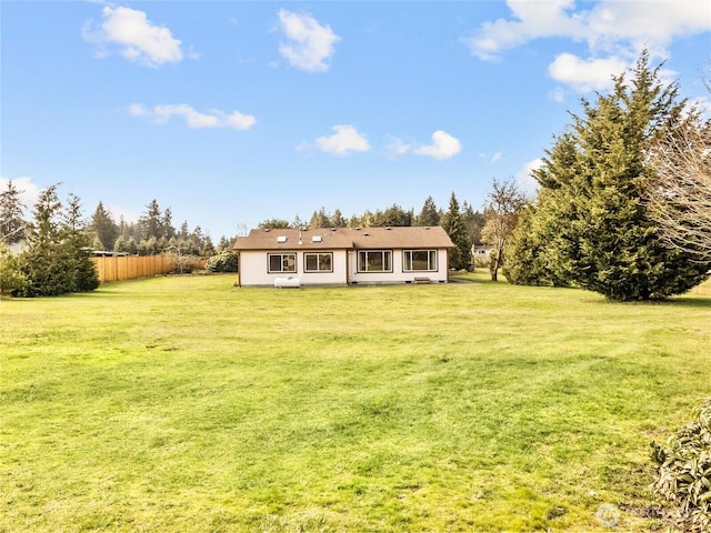 exterior space with a lawn and fence