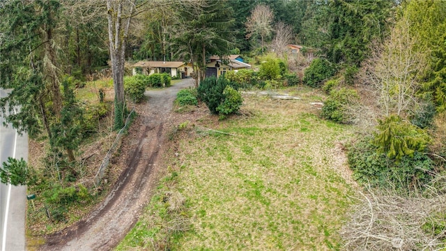 birds eye view of property featuring a wooded view