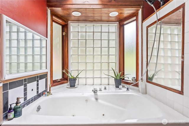 full bathroom featuring a jetted tub, wooden ceiling, and a wealth of natural light