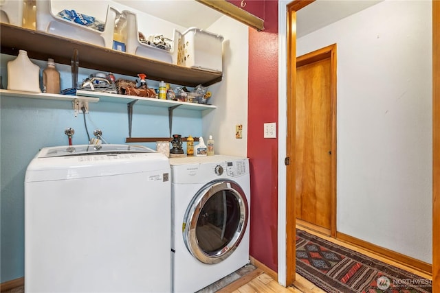 washroom with laundry area, baseboards, separate washer and dryer, and light wood finished floors