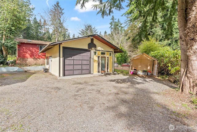 garage with gravel driveway