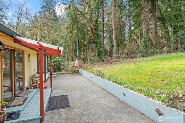 view of patio / terrace featuring a forest view