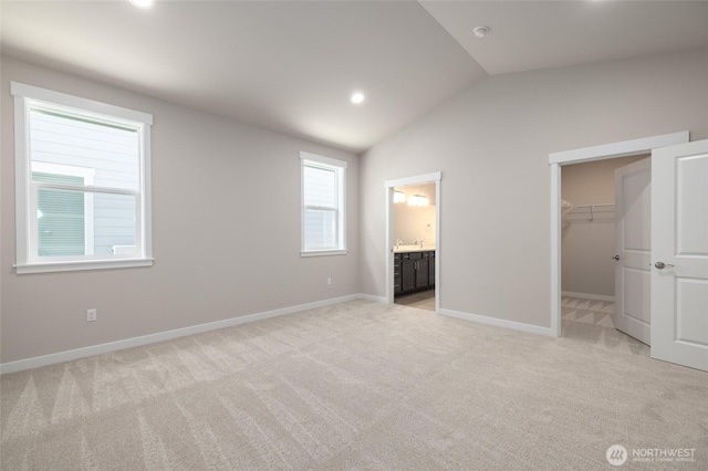 776 Parkland Loop, Sedro Woolley, WA 98284 - unfurnished bedroom with a spacious closet, lofted ceiling, light carpet, baseboards, and recessed lighting
