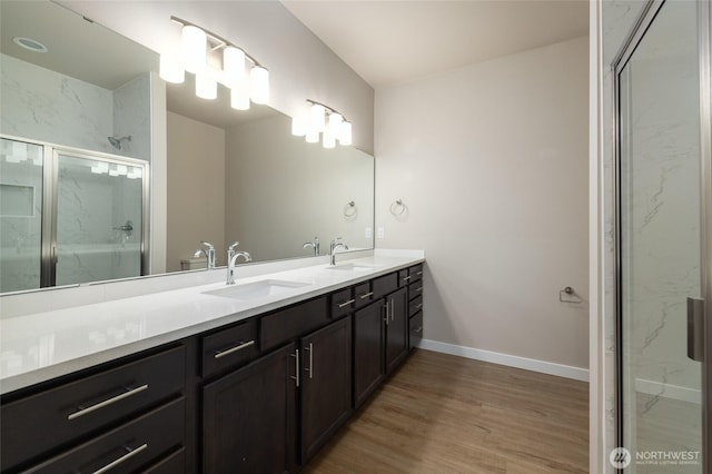 776 Parkland Loop, Sedro Woolley, WA 98284 - full bathroom with wood finished floors, double vanity, a marble finish shower, and baseboards