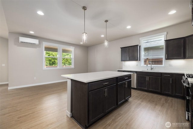 776 Parkland Loop, Sedro Woolley, WA 98284 - kitchen with a sink, appliances with stainless steel finishes, a wall unit AC, light wood-style floors, and recessed lighting