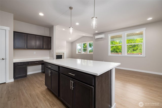 776 Parkland Loop, Sedro Woolley, WA 98284 - kitchen featuring a wall mounted AC, light wood-style flooring, a fireplace, light countertops, and vaulted ceiling