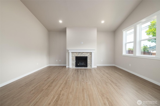 776 Parkland Loop, Sedro Woolley, WA 98284 - unfurnished living room featuring light wood-type flooring, a stone fireplace, baseboards, and recessed lighting