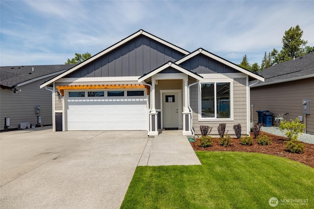 776 Parkland Loop, Sedro Woolley, WA 98284 - view of front of house with board and batten siding, driveway, an attached garage, and a front lawn
